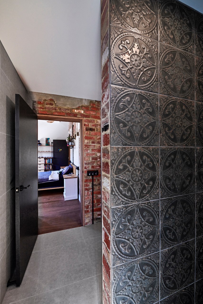 Lanes End pressed-metal tile wall beside a bedroom doorway