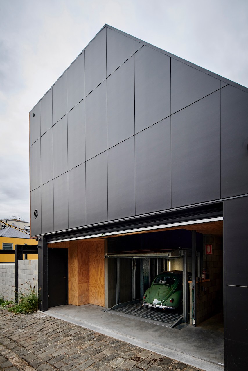 Lanes End charcoal-clad rear facade with garage and classic car