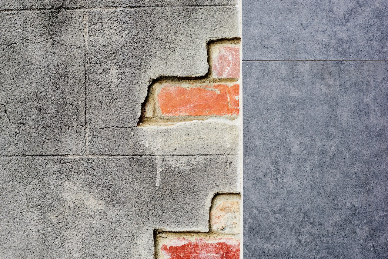 Lanes End material detail — exposed brick meeting concrete