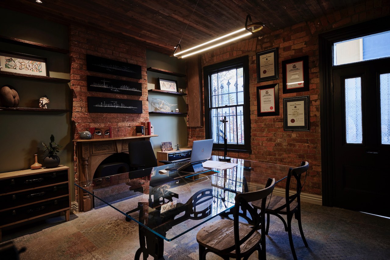Lanes End home studio with exposed brick and glass desk
