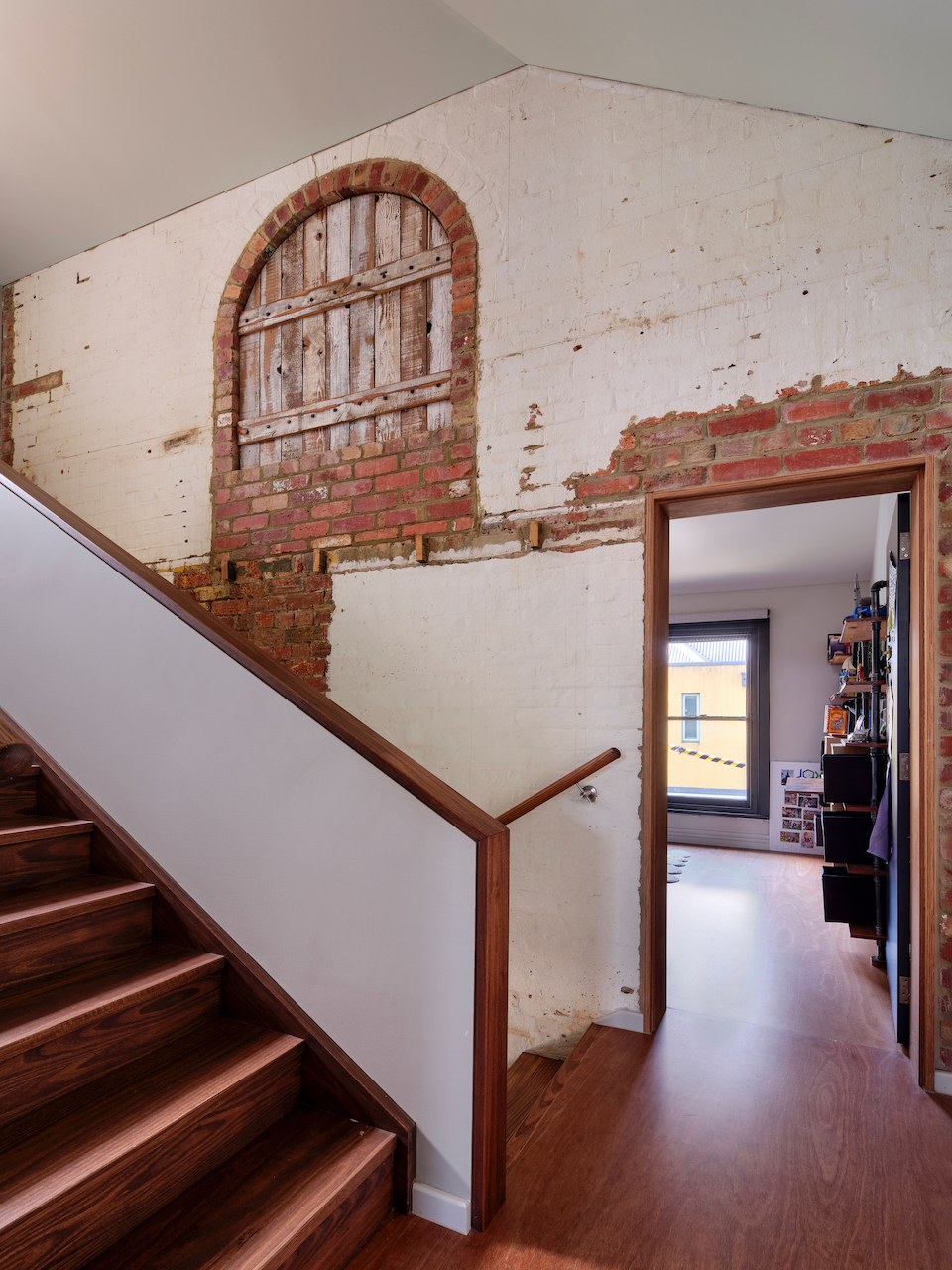 Lanes End heritage stair landing with arched door